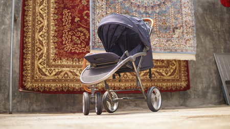 A stroller on the background of a carpet. Close-up.の写真素材
