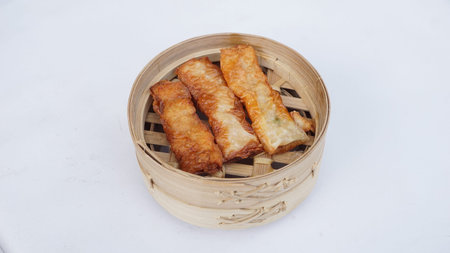Fried Dumplings in Bamboo Basket on White Background.