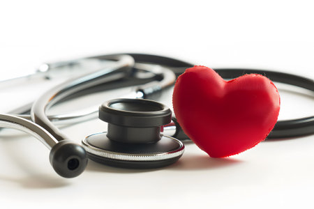 Stethoscope and red heart on white background. Healthcare and medical conceptの素材