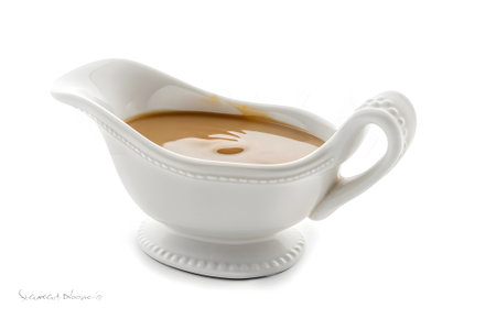 sauce boat with turkey gravy on white backgroundの素材
