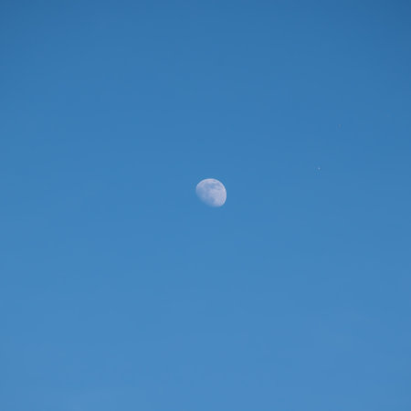 White moon against the blue skyの写真素材