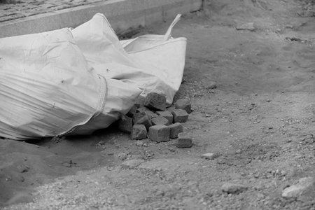 Scattered paving stones and a bag for transportの写真素材