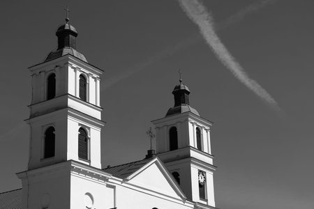 Church spiers and a white streak in the gray sky