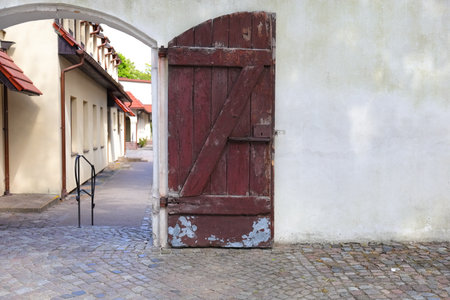 Brown wooden door on a white wallの写真素材