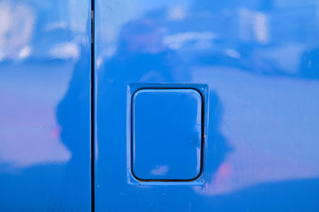 A fuel filler cap on a blue car body