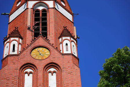 The clock on the tower and the blue sky in the background