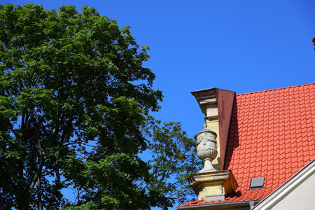 Colorful roof fragment and green leavesの写真素材