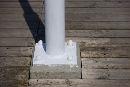 Four white screws and wooden boards aroundの写真素材