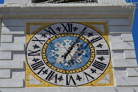 A clock on the wall with Roman numerals