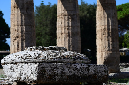 Square and round stone against the background of columnsの写真素材