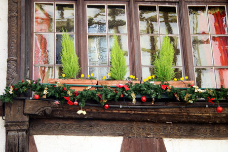 typical bavarian christmas decoration in front of a windowの写真素材