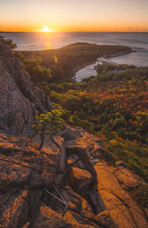 Epic Acadia National Park Sunrise Beehive Trail in Autumn Wide Landscape in Maine. Colorful Trees, Rock Climbing Trail Sun Rise Over Oceanの写真素材