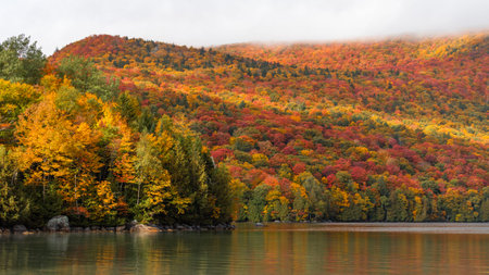 Beautiful Sunrise Light Sweeps Across Lake Willoughby in Vermont, USA. Small New England Tourist...