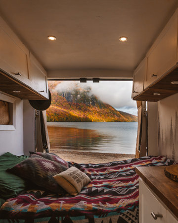 Camper Van Interior Custom Build Beautiful View Vanlife Doors Open Autumn Scene Lake Camping Colorful Fall Foliage. Bed Blanket Pillowsの写真素材