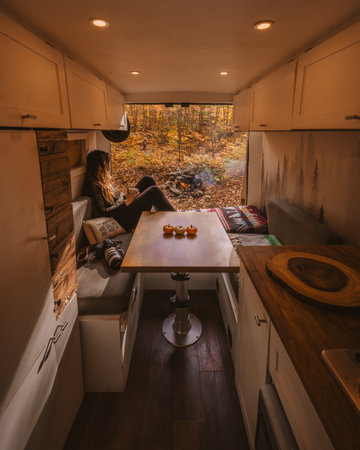 Autumn Vanlife Female Traveler Digital Nomad Camping New England Fall Foliage. Camera, Coffee Cup, Pumpkins, Doors Open, Campfire Burning. Camperの写真素材