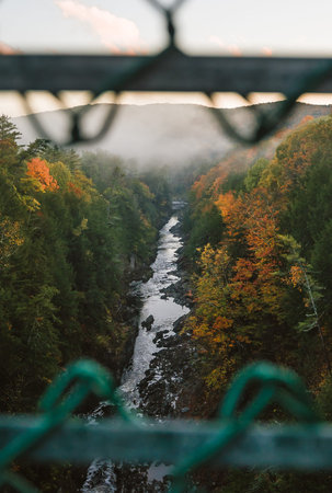 Quechee Gorge Vermont River Early Morning Fog View Through Green Fence. Landscape Moody Beautiful Nature.の写真素材