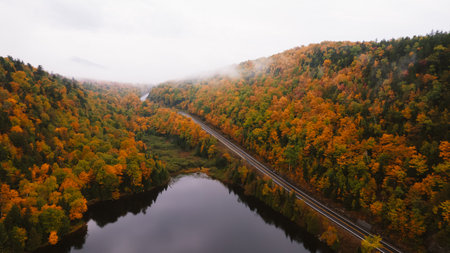 Autumn Aerial Fall Foliage Road Cascade Lakes Adirondacks New York New England. Colorful Forest Road Scenic Drive Low Clouds Moody Beautyの写真素材