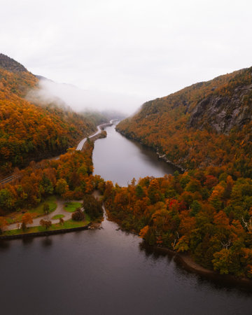 Beautiful Early Morning Clouds Over Scenic New England Adirondacks Lakes. Forest of Colorful Fall Foliage Trees Cascade Lakes Aerial View Scenic Roadの写真素材