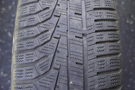 Car tire pattern, close-up of a car tire on the roadの写真素材