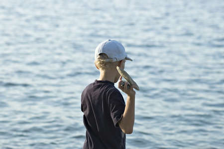 The child plays on a stone beachの写真素材