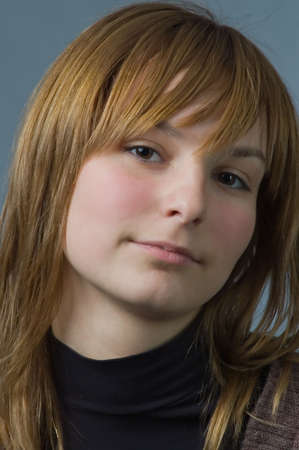 The girl on grey a background with the confident and cynical sightの写真素材