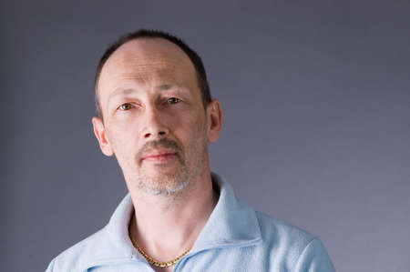 The man in a sweater isolated on gray backgroundの写真素材