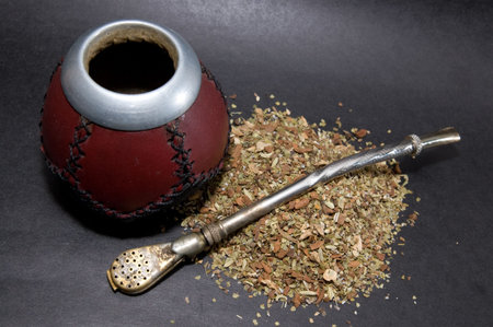 Cup from calabash with yerba mate tea and straw.