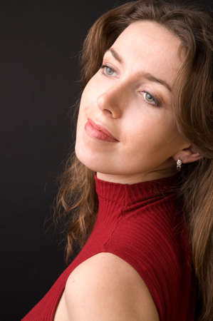The beautiful girl in studio on a black background.の写真素材