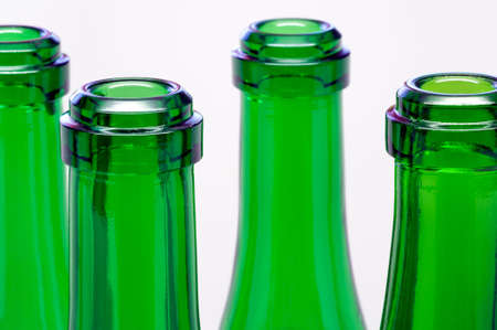 Green bottles necks close-up over white backgroundの写真素材