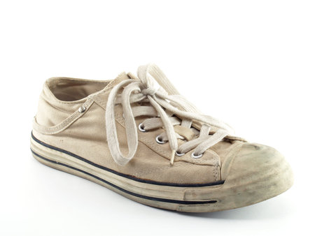 Old white sneakers Isolated on white backgroundの写真素材