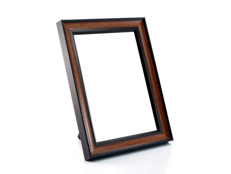 close-up blank simple wooden picture frame isolated on white background, dark brown wood desktop...