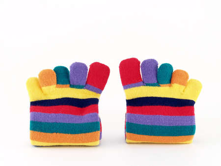 close-up colorful striped long finger socks isolated on white background, vivid colors five toes socks winter fashion for teenage female or childrenの写真素材