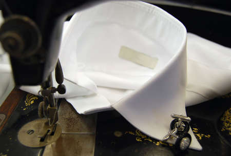 Old sewing machine on a white shirt collarの写真素材