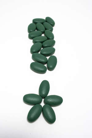 Exclamation point made of pills on white backgroundの写真素材