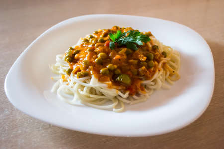 Spaghetti on the white plate on the table.の写真素材
