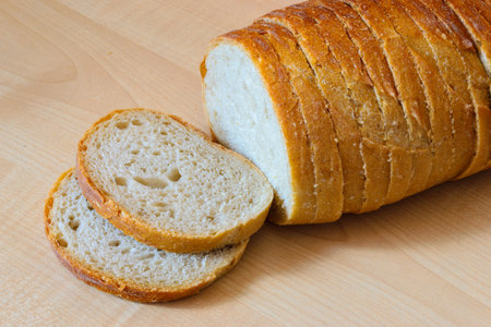 Loaf of bread on the wooden table. Indoor.