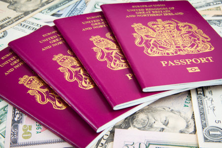 UK Passport on a pile of US Dollars