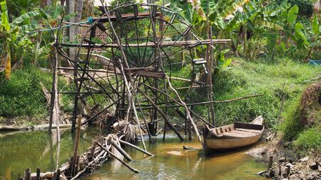 Fisherman in boat catching fish with cast net fishing in the river in siem reap cambodia asiaの写真素材