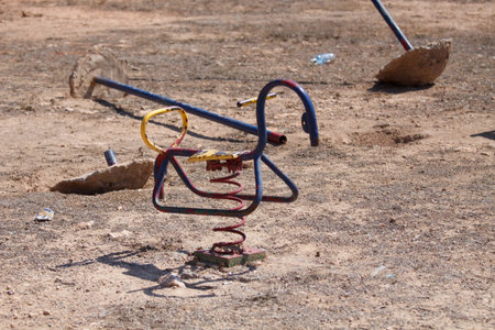 abandoned playground in sparse landscape