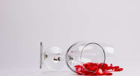 two wine glassed with hearts spilling out of themの写真素材