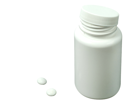 two white pills with white jar on a black backgroundの写真素材