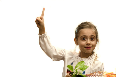 smiling girl with a raised index finger isolated on a white backgroundの写真素材