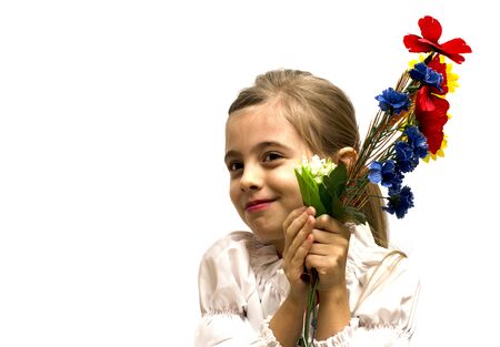 smiling little girl with a bouquet of flowers isolated on a white backgroundの写真素材
