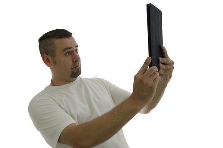 man makes a selfie on the tablet on white backgroundの写真素材