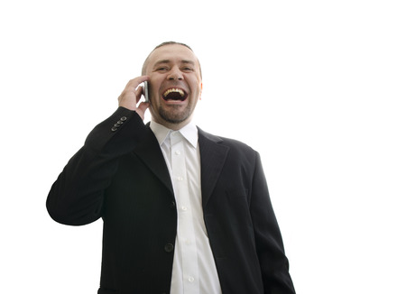 businessman in jacket laughing and talking on the phone isolated on white backgroundの写真素材