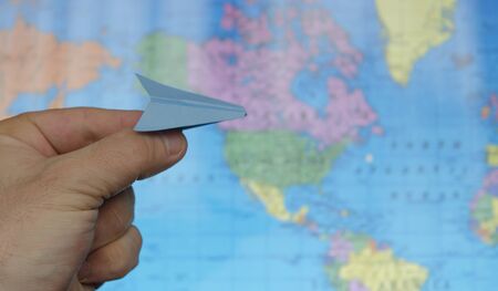 paper airplane on a background map of the worldの写真素材