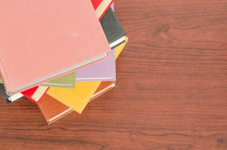 a stack of colorful books in a library or a roomの写真素材