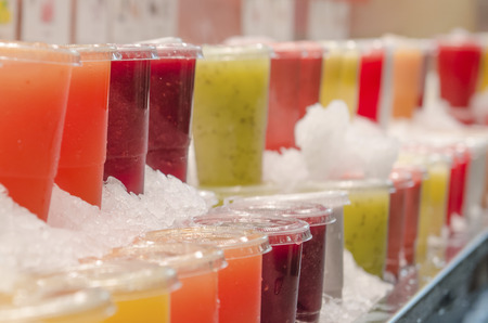Freshly squeezed juice on market shelves in Barcelonaの写真素材