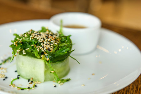 green salad with sesame on a white plate