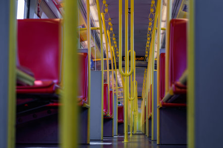 Interior view of a corridor inside passenger trains with red fabric seats. Empty vacant passenger...